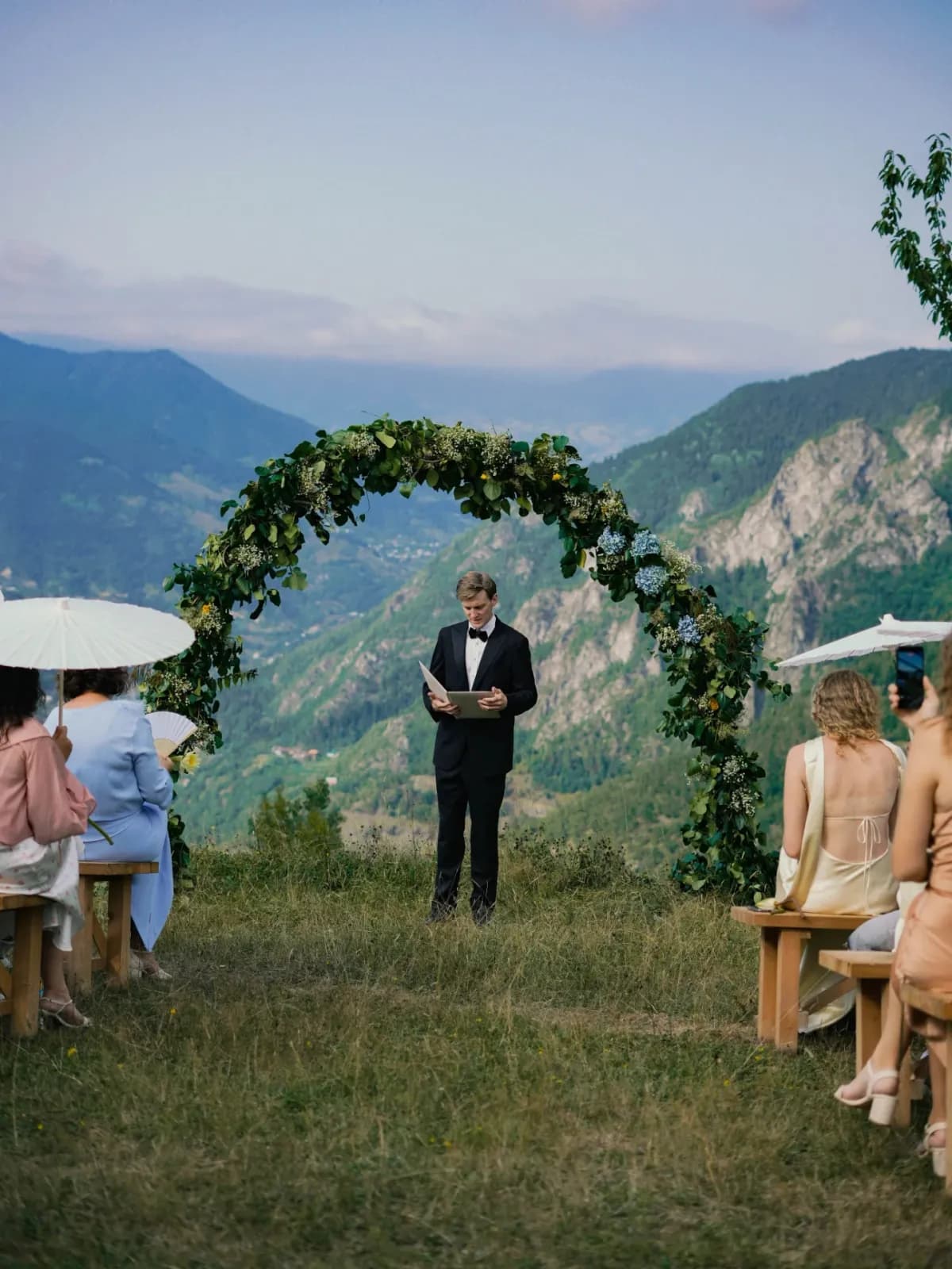 Wedding ceremony under a flower arch on the ridge