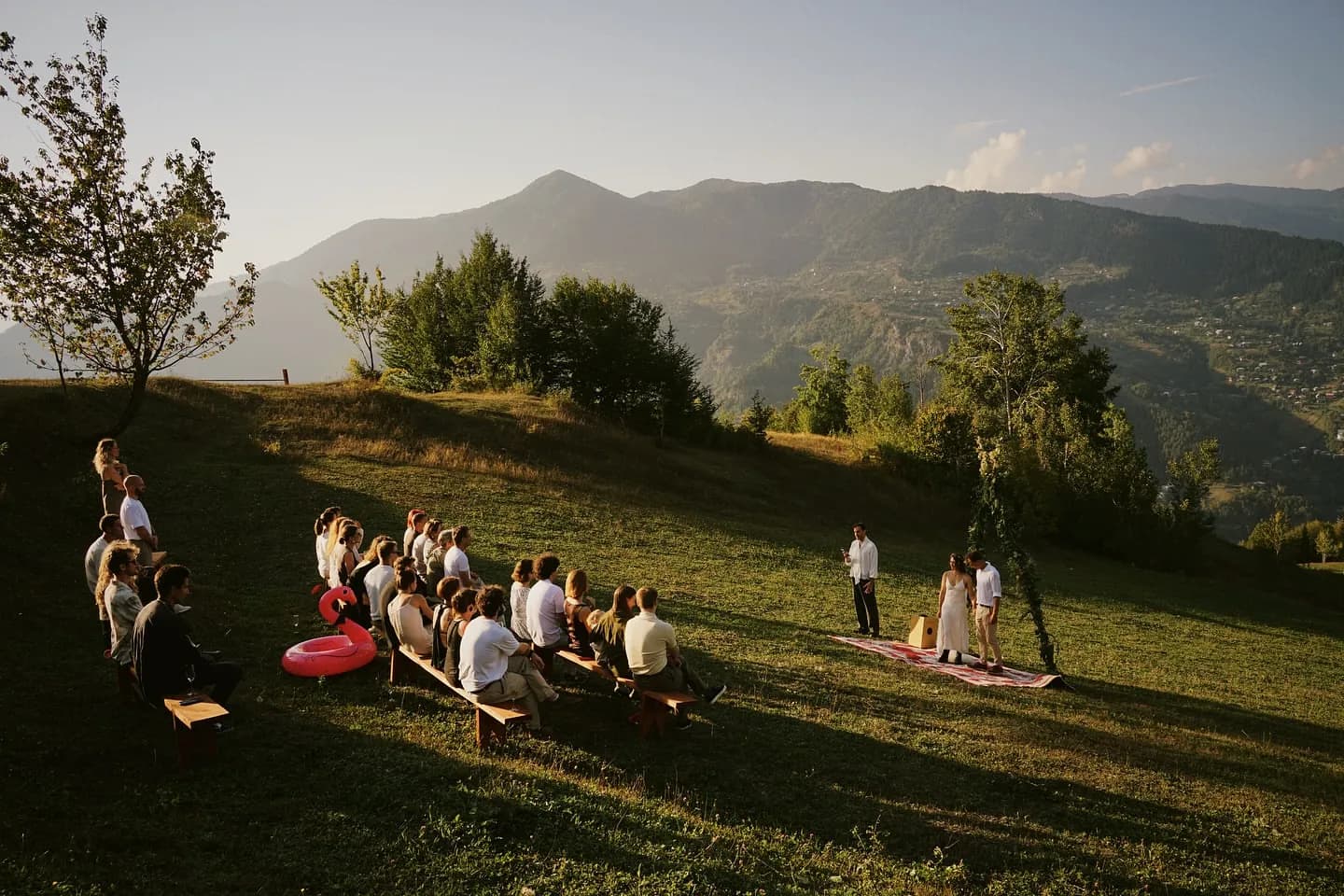 Guests seated on the hillside for an open-air ceremony