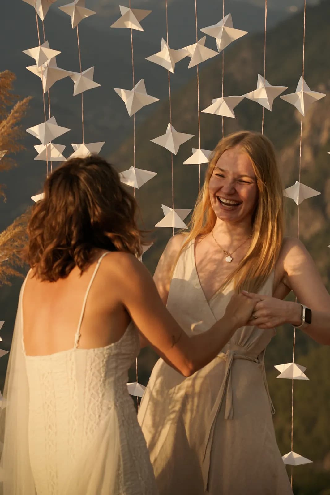 Guests laughing under the paper-star decorations