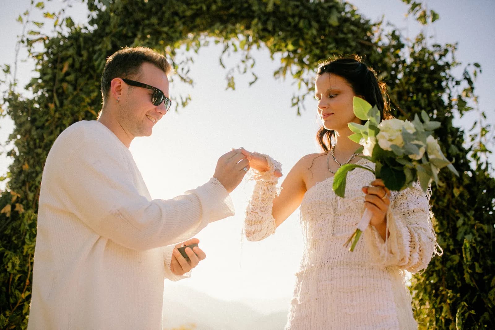 The couple toasting, bride holding her bouquet