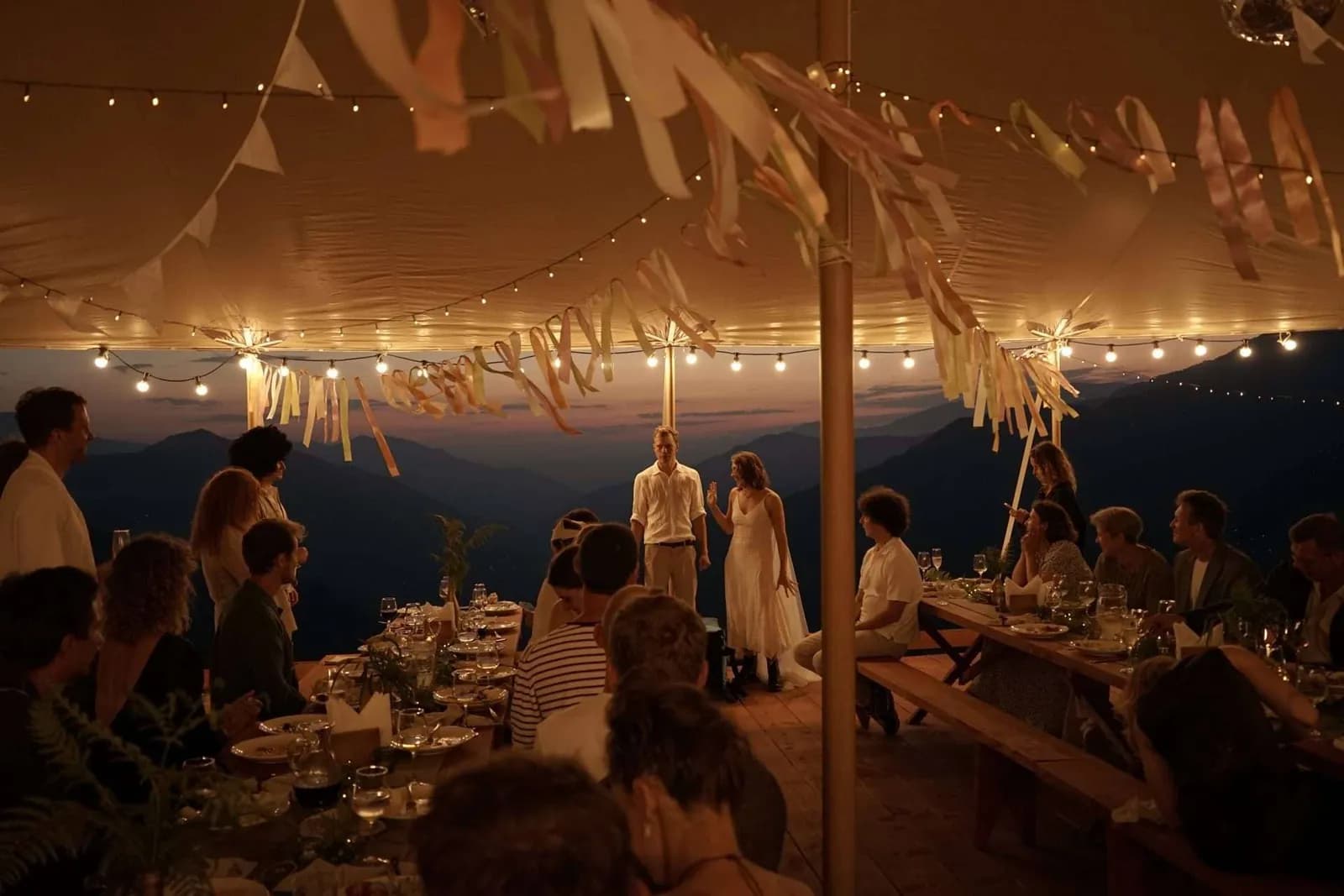 The evening feast under garlands inside the tent